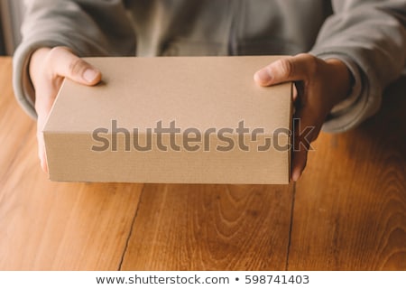 Stockfoto: Man Holding Cardboard Box Package For Mock Up Design