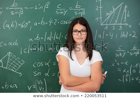 Zdjęcia stock: The Young Female Math Teacher In Front Of Chalkboard