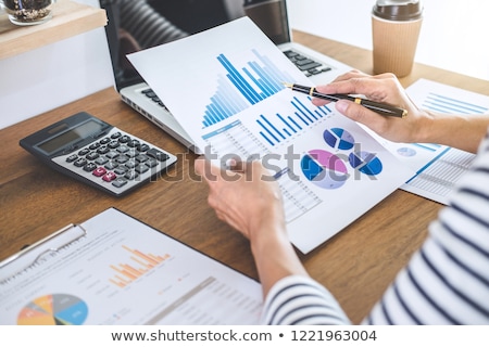 Foto stock: Female Accountant Calculations And Analyzing Financial Graph Dat