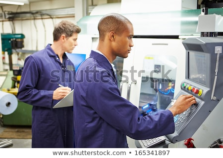 Stock photo: Worker Operating Industrial Milling Machine