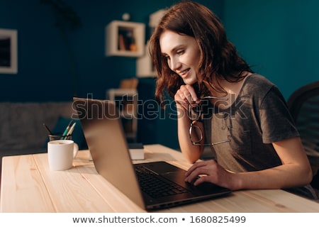 Сток-фото: Pretty Young Woman Working At Home In The Evening