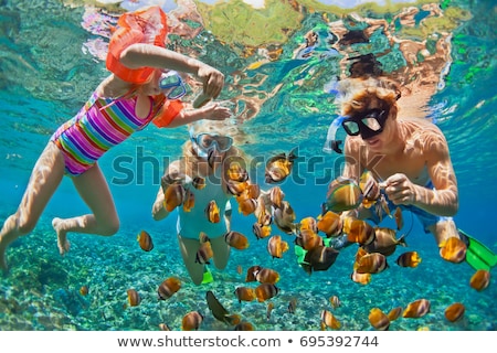 Foto stock: Happy Family - Active Kid In Snorkeling Mask Dive Underwater See Tropical Fish In Coral Reef Sea Po