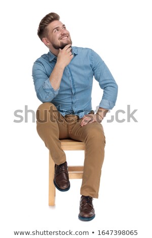 Сток-фото: Seated Young Pensive Man Looking Up