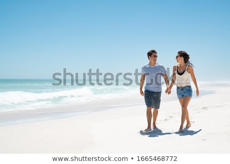 ストックフォト: People Cheering Each Other On Beach