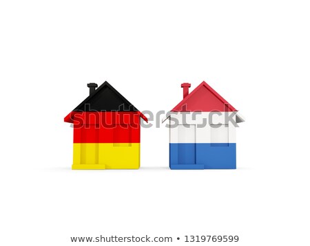 Foto stock: Two Houses With Flags Of Germany And Netherlands