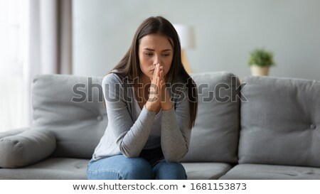 Stockfoto: Image Of Anxious Family Sitting On Sofa At Home And Looking At Y