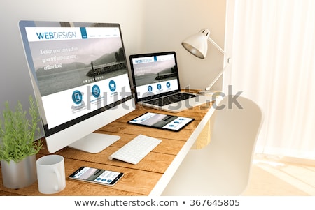 Foto stock: Web Designer With Smartphone And Laptop At Office