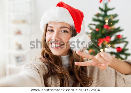 Stockfoto: Woman Taking Selfie Over Christmas Tree