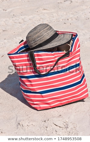 Zdjęcia stock: Top View Of Sandy Beach With Red Striped Beach Hat Background Wi