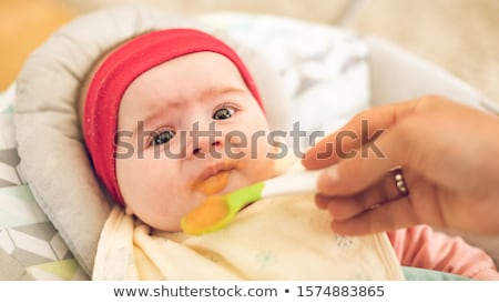 Stock fotó: Mother Feeding Hungry Six Month Old Baby Solid Food