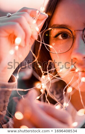 Foto stock: Young Woman In Jacket Standing On Balcony With City Background A