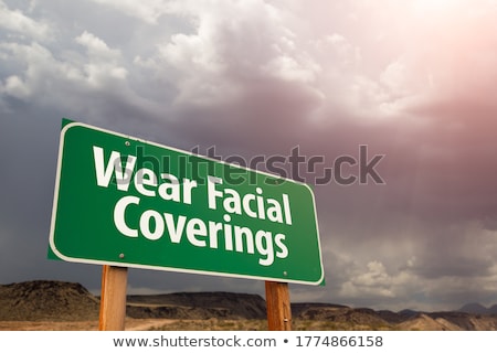 Stock photo: Covid 19 Coronavirus Green Road Sign Against Ominous Stormy Clou