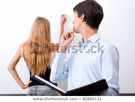 Foto stock: Closeup Of Adult Teacher With Student Presenting Her Work On Whi