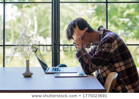 Stock photo: Man Lies On The Table Thinking Depression And Fatigue