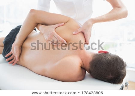 Foto d'archivio: Male Therapist Giving Shoulder Massage