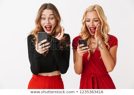 Сток-фото: Portrait Of Two Excited Young Smartly Dressed Women