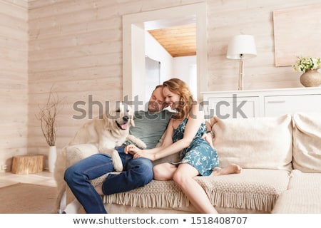 Stockfoto: A Nice Men On Sofa With Dog