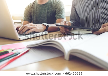 Foto stock: Young Students Classmates Help Friend Catching Up Workbook And L