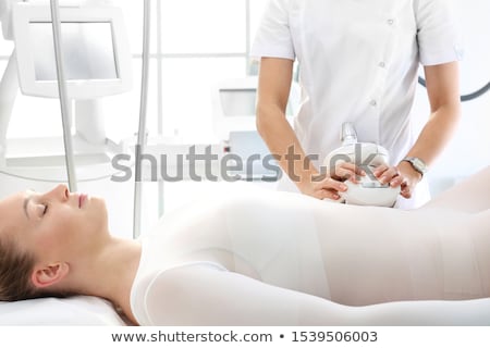 Foto stock: Beautician Using Cellulite Vacuum On Womans Thigh