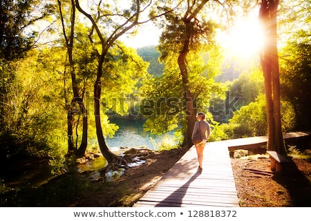 Stock photo: Young Woman Walking By Hiking Trail