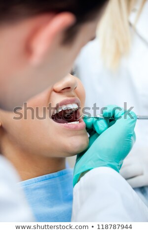 Foto stock: Close Up Of Dentist Examining Patient