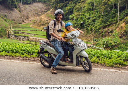 [[stock_photo]]: Father And Son Are Traveling On A Moped On A Tea Plantation In Malaysia Traveling With Children Con