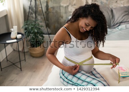 Stock foto: Pregnant Woman Taking Measurement Of Her Belly