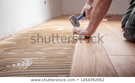 [[stock_photo]]: Hammer And Block With New Laminate Flooring