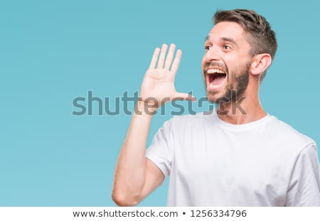 Stock photo: Young Handsome Man Shouting And Screaming Loud To Side With Hand On Mouth And Copy Space For Text
