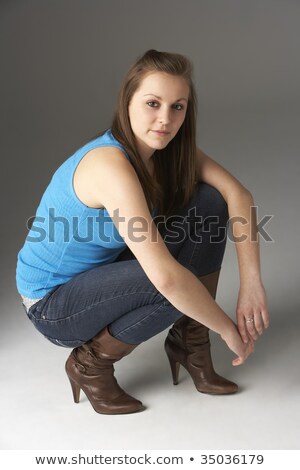 Stockfoto: Portrait Of A Pretty Teenage Girl Crouching