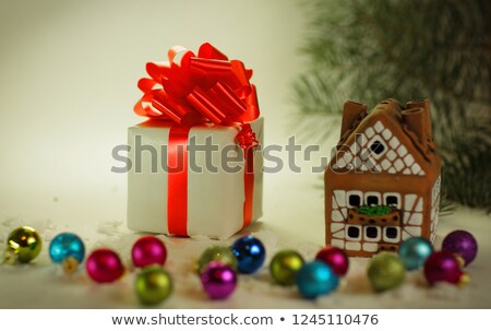 ストックフォト: Christmas Tree Branch With A Gift In A Red Box On A White Backgr