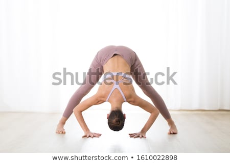 Stok fotoğraf: Young Woman In Separate Leg Stretching Pose