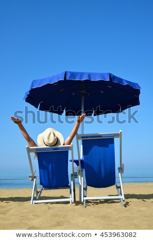 [[stock_photo]]: Girl In A Deckchair On The Beach