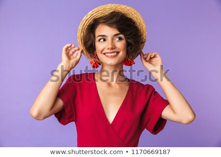 Foto stock: Pleased Elegant Woman In Dress And Straw Hat Posing