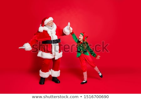 Stockfoto: Excited Young Woman Wearing Red Santa Claus Hat