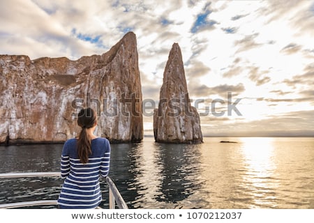 [[stock_photo]]: Galapagos Cruise Ship Tourist On Boat Looking At Kicker Rock Nature Landscape
