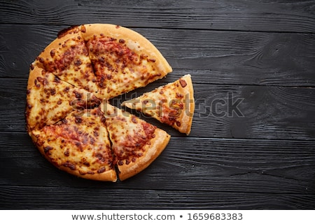 Foto d'archivio: Fluffy Pepperoni Pizza In American Style Placed On Rusty Old Black Wooden Table