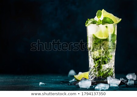Stockfoto: Highball Glass Of Mojito Summer Alcoholic Cocktail With Ice Cubes Mint And Lime On White With Cane S