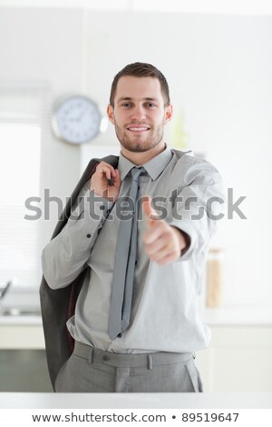 Stockfoto: Business Man Holds His Jacket And Ok Sign