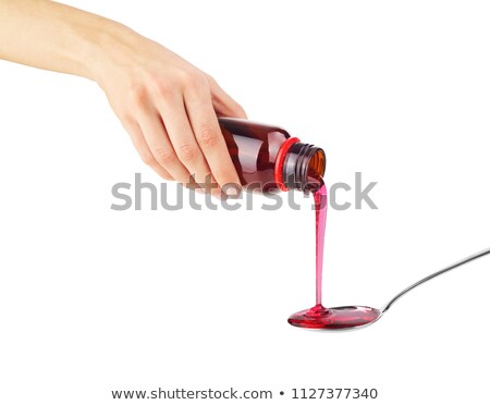 Stok fotoğraf: A Woman Pouring A Spoon Of Syrup