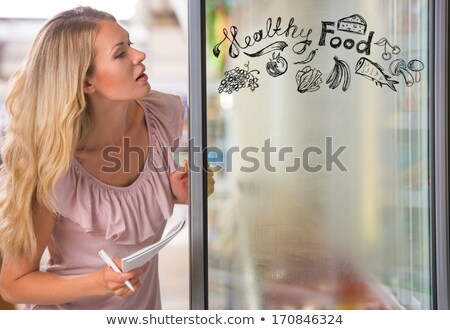 Stok fotoğraf: Young Pretty Woman Thinking Of Healthy Food While Shopping At Gr
