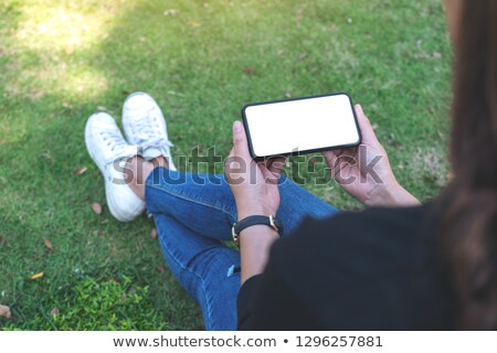 Stock fotó: Hand Holding Mobile Smartphone With Blank Screen Horizontally On White Background