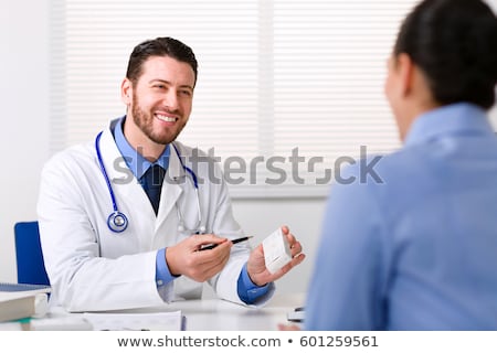 Stock photo: Doctor Hand Holding Tablet Of Drug And Explain To Patient In Ho