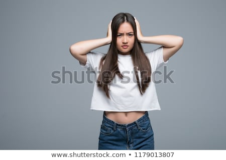 Foto stock: Angry Brunette Woman In Casual Clothes Covering Her Ears