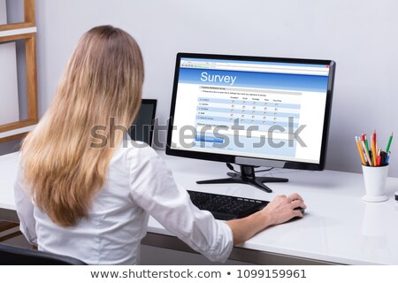 [[stock_photo]]: Businesswoman Filling Survey On Laptop