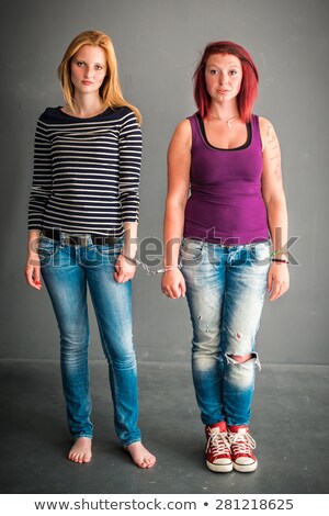 Foto d'archivio: Two Angry Women Connected By A Pair Of Handcuffs