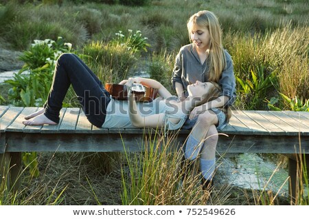 Stock photo: Girls Playing Guitar On Boardwalk