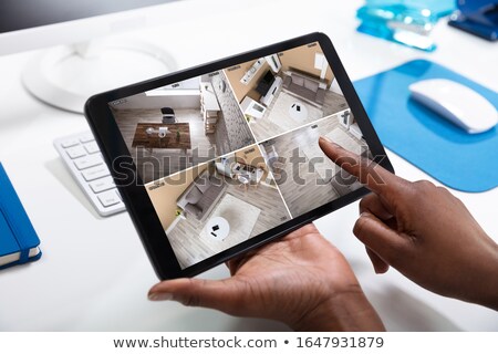 Сток-фото: Close Up Of A Woman Monitoring Cameras Live On Digital Tablet