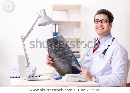 Foto stock: Young Handsome Doctor Radiologist Working In The Clinic