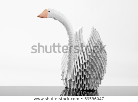 Foto stock: White Origami Swan On Grey Surface